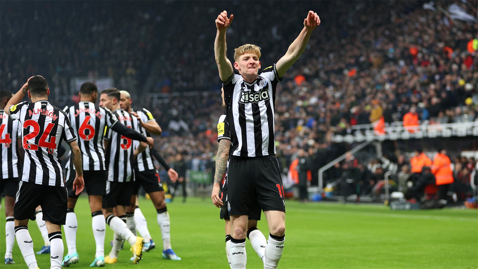  A Newcastle United player celebrates scoring a goal in front of the home crowd at St. James' Park while the club is rumored to be selling players.